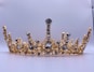 a gold crown with black and white stones