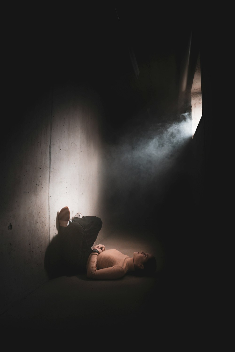 a person laying on the ground in the dark