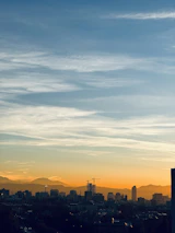Denver city skyline at sunset, symbolizing local roots and opportunity.
