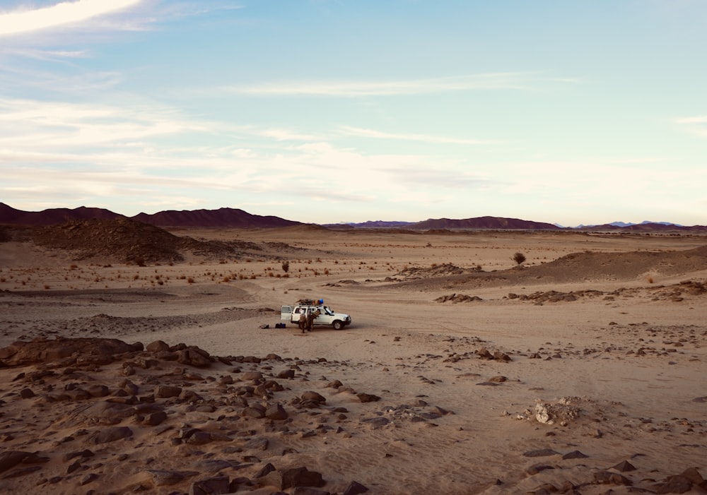 a truck is driving through a desert area