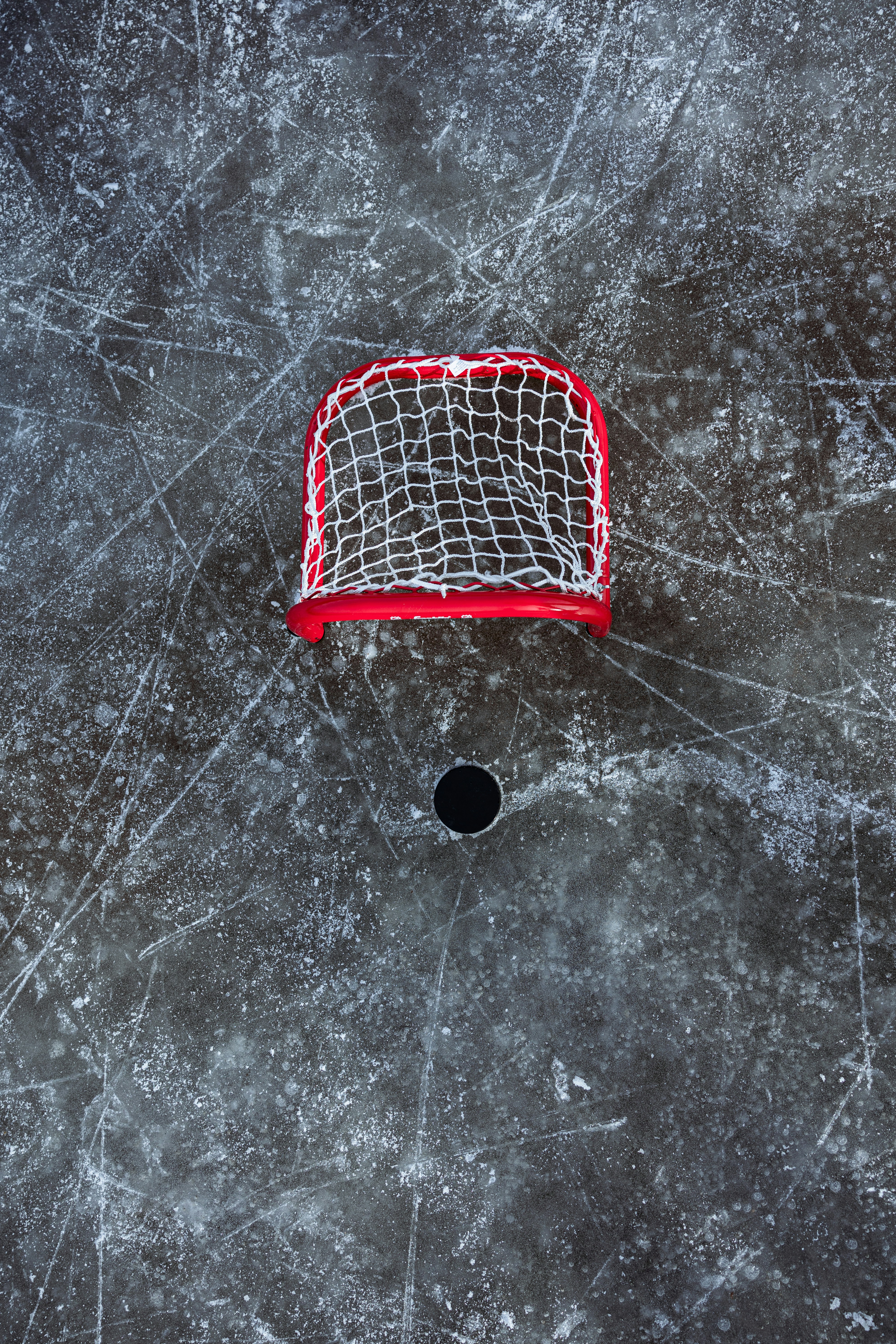 a hockey goal sitting on top of an ice rink