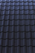 a close up of a metal roof with a sky background