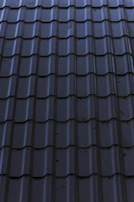 a close up of a metal roof with a sky background
