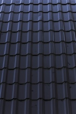 a close up of a metal roof with a sky background