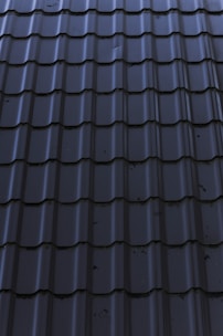 a close up of a metal roof with a sky background
