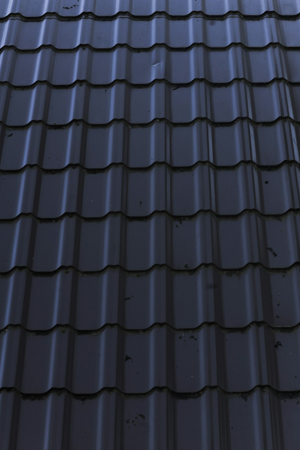 a close up of a metal roof with a sky background