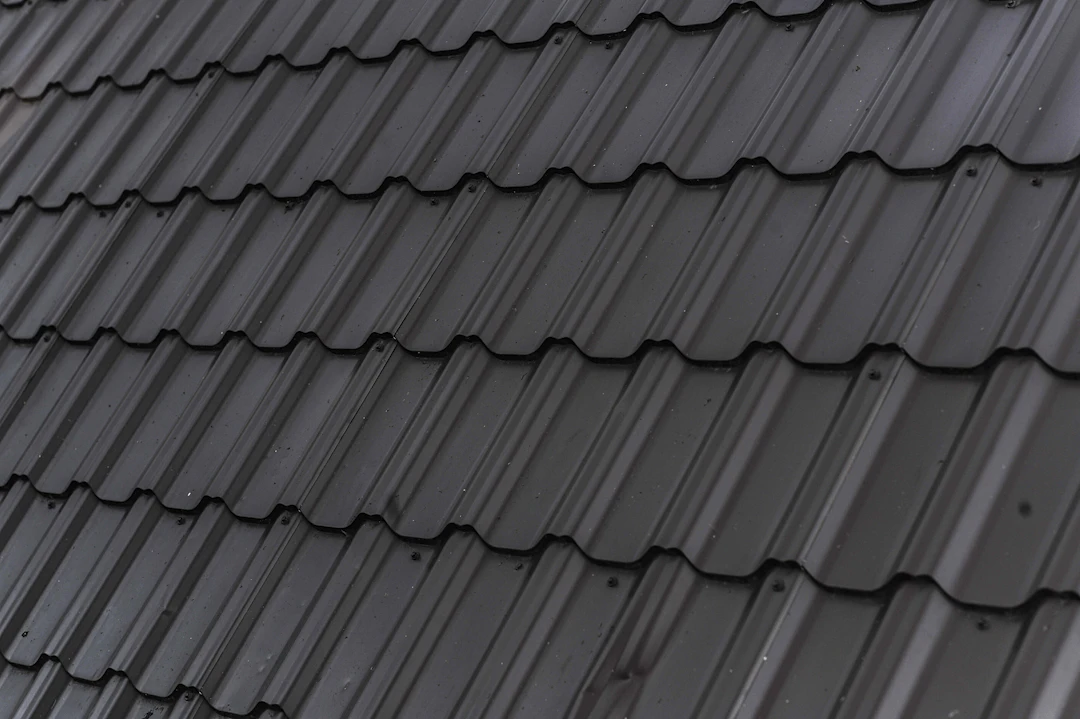 Close-up of dark architectural asphalt shingles on a pitched roof