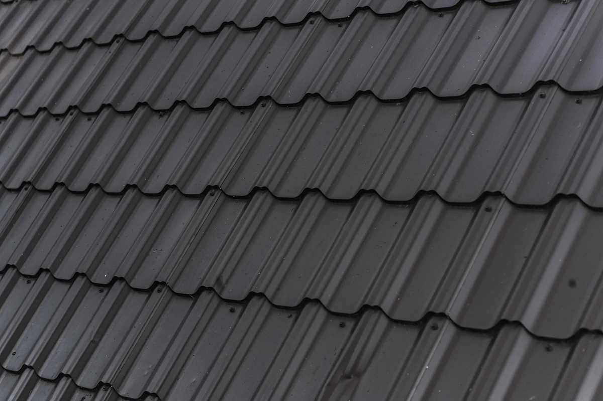 A neatly finished charcoal slate tiled roof showing tidy, even courses