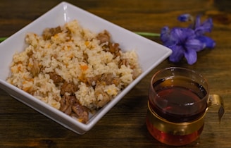 a bowl of rice and a cup of tea on a table