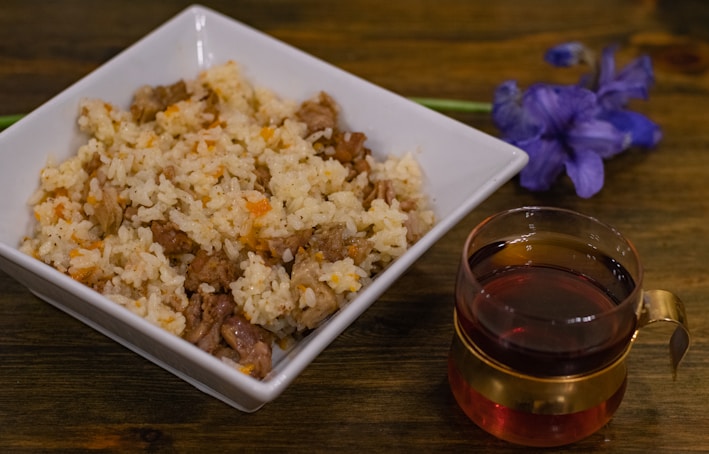 a bowl of rice and a cup of tea on a table