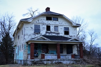 an old run down house with graffiti on it