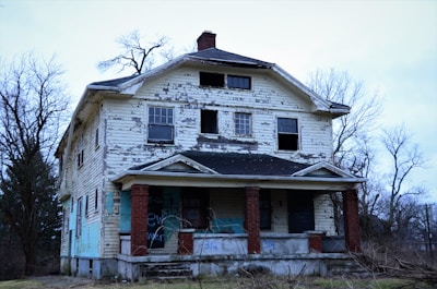 an old run down house with graffiti on it