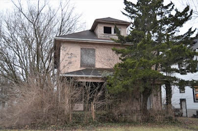 a run down house with a broken window