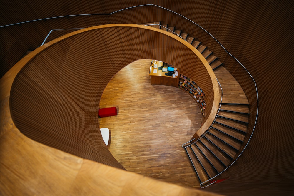 a spiral staircase in a library with bookshelves