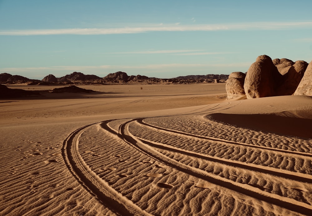 a tire track in the middle of a desert