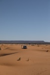 a car in the middle of the desert