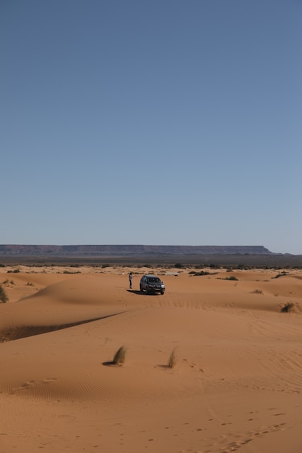 a car in the middle of the desert