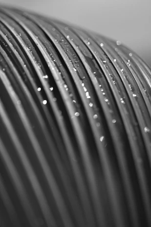 a black and white photo of water droplets on a pipe
