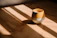 Close-up of a handmade stoneware cup with warm morning light.
