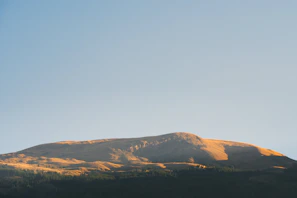 A serene mountain landscape bathed in golden sunset light