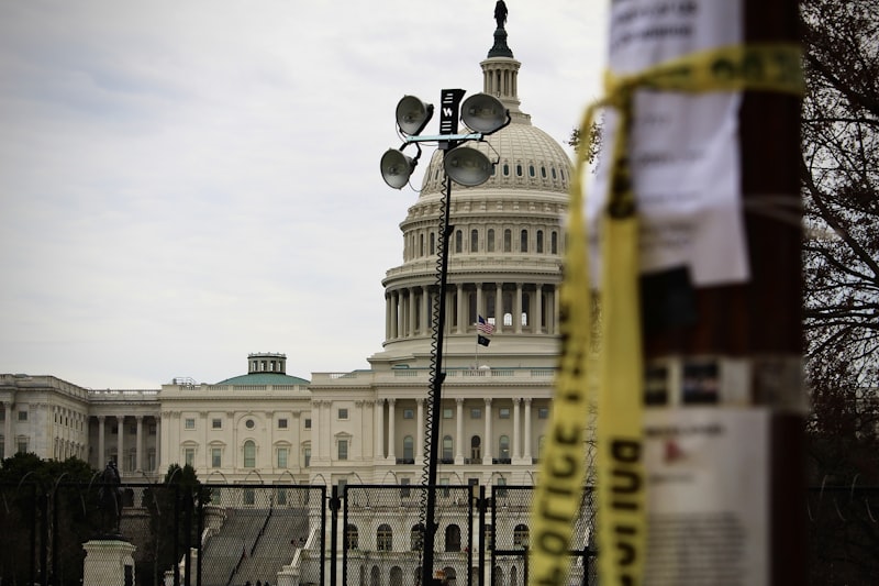 US Capitol building behind security fencing and police tape