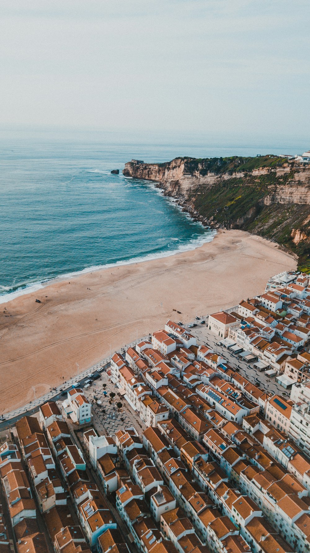 a bird's eye view of a beach and a city