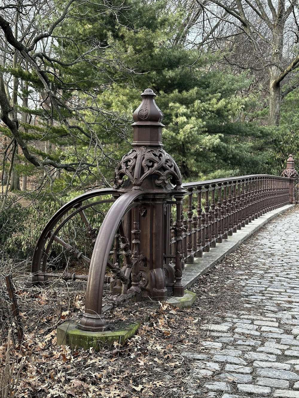 a metal fence with a water feature on top of it