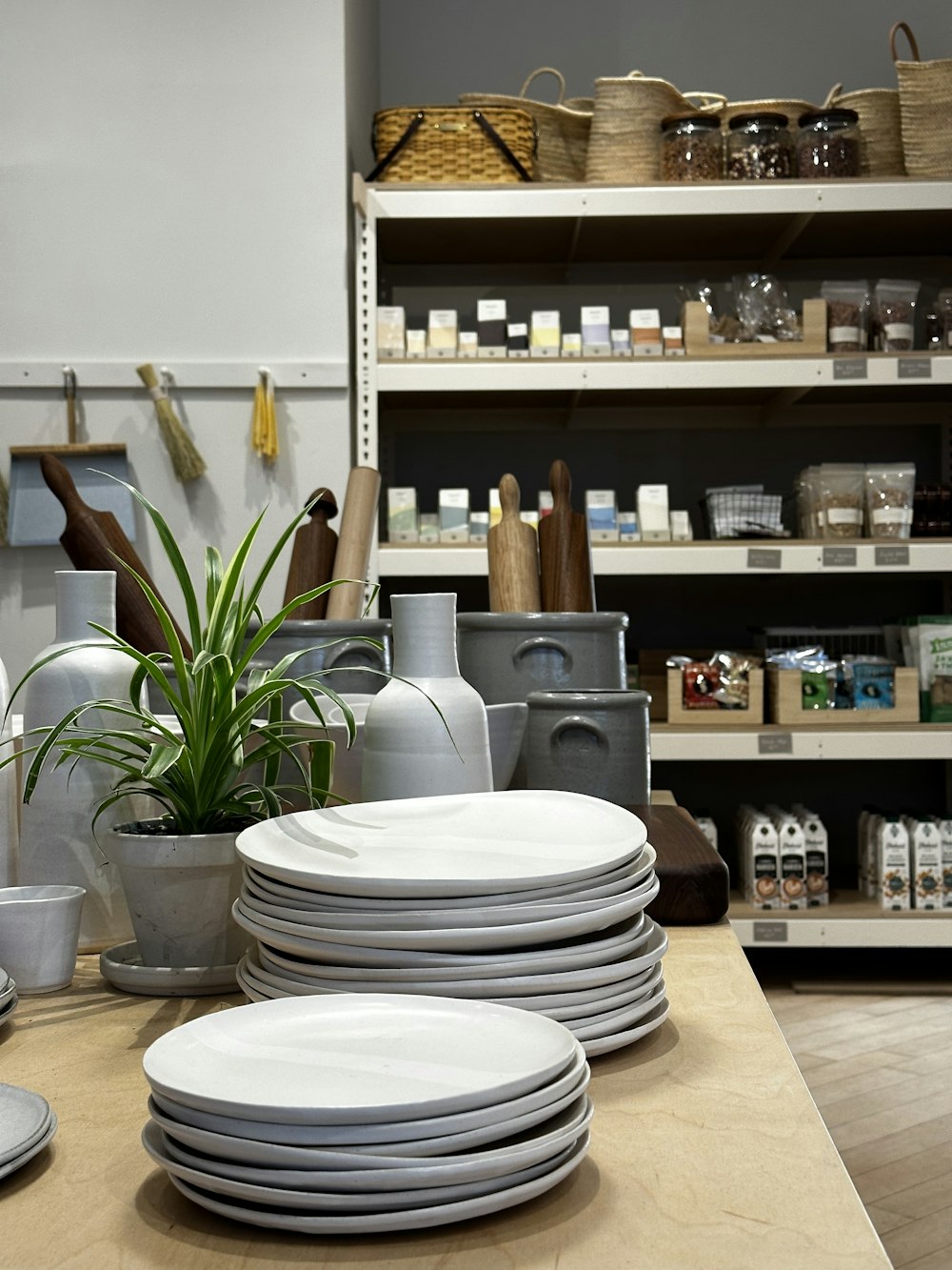 a stack of white plates sitting on top of a wooden table