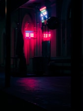 A gritty neon-lit Kansas City street at night, with shadowy figures and glowing occult glyphs.