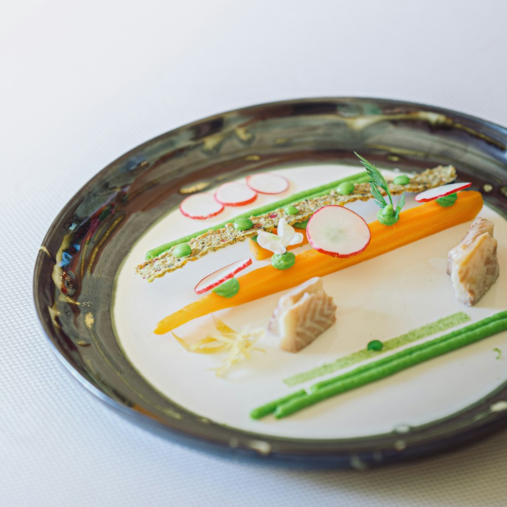 a plate of food with carrots, celery, and radishes