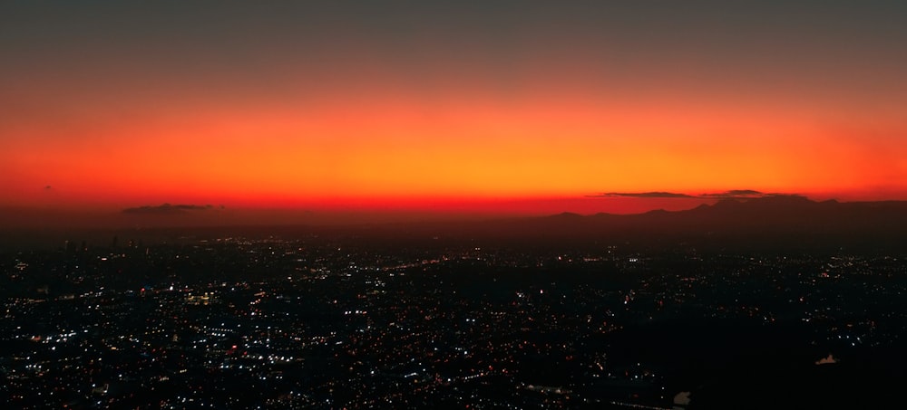 a view of a city at sunset from an airplane