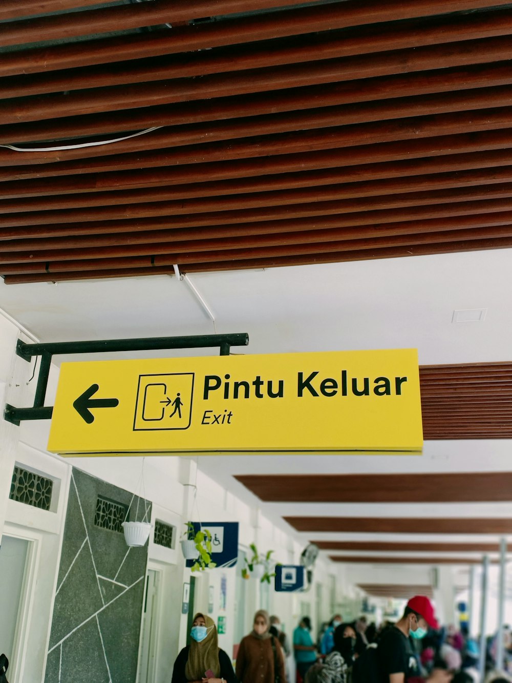 a yellow sign hanging from the ceiling of a building