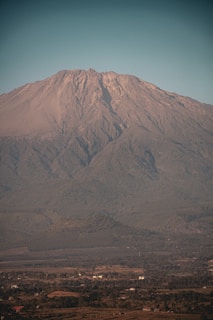 a large mountain with a very tall peak in the distance
