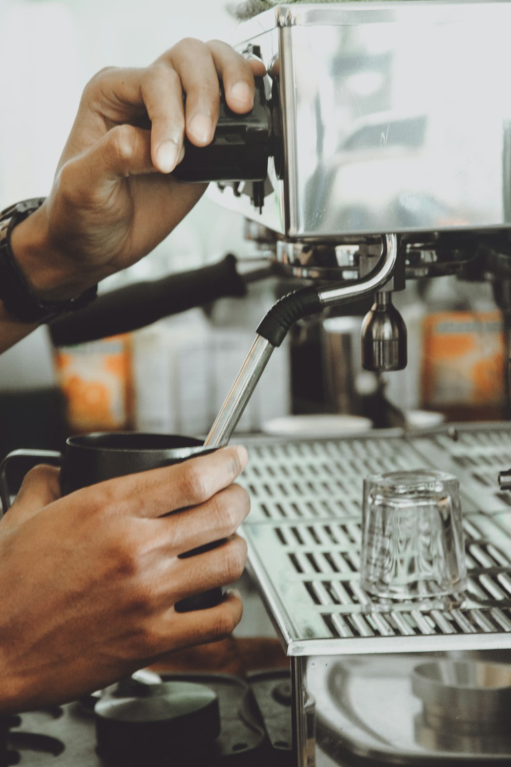 a person using a coffee machine to make a cup of coffee