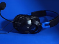 a pair of headphones sitting on top of a blue surface