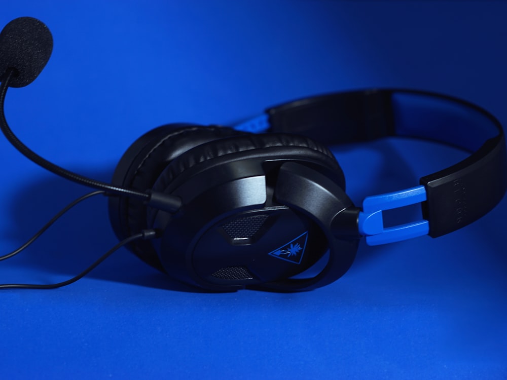 a pair of headphones sitting on top of a blue surface