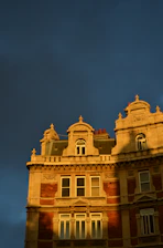 A stately Edwardian building bathed in warm afternoon light, symbolizing stability and heritage.