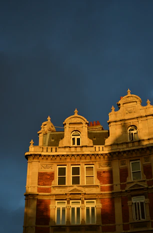 A stately Edwardian building bathed in warm afternoon light, symbolizing stability and heritage.