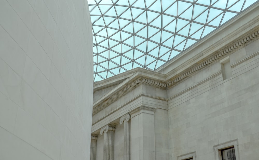 a building with a glass roof and columns