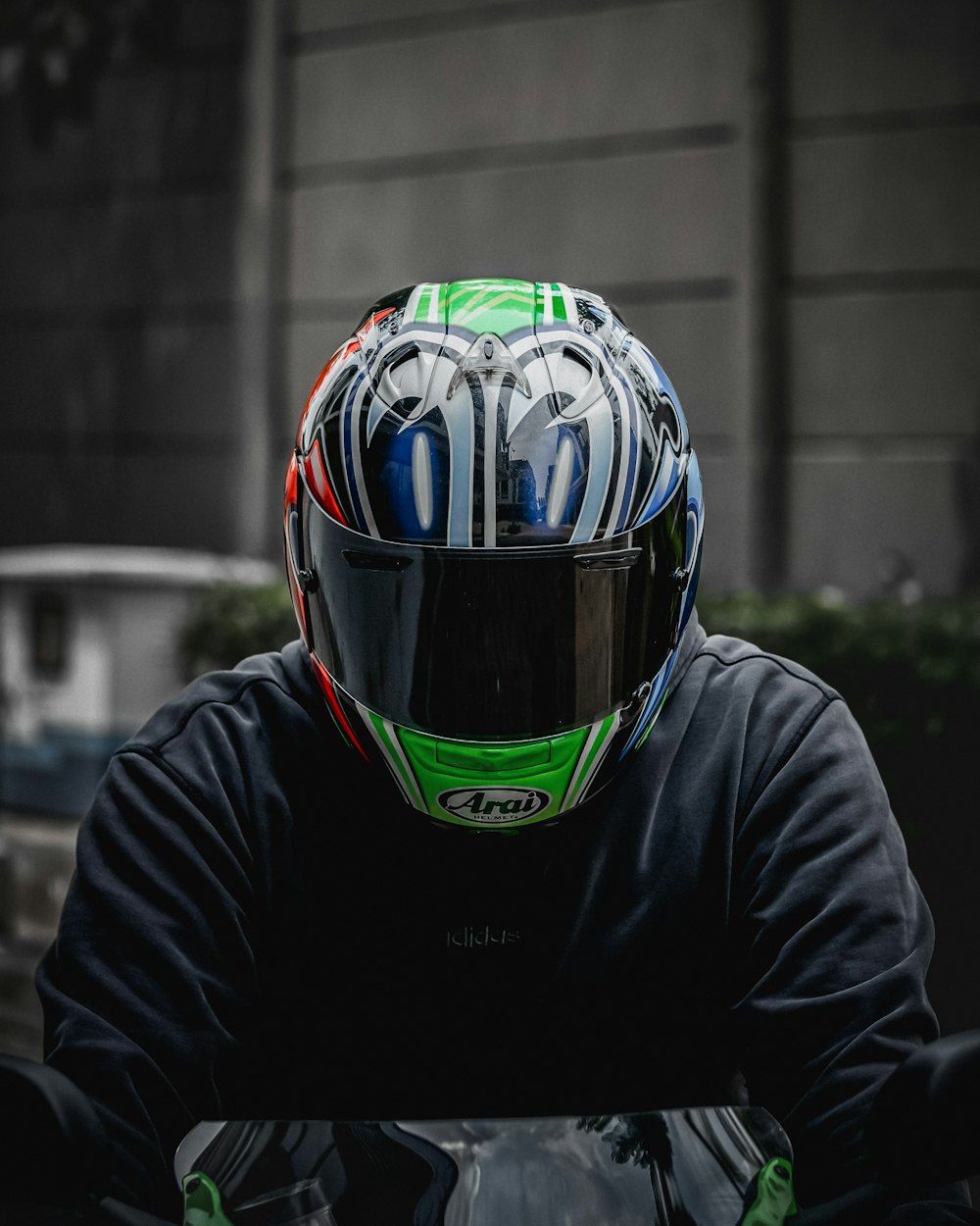 a person wearing a helmet and sitting on a motorcycle