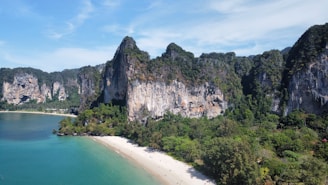 an aerial view of a sandy beach surrounded by mountains