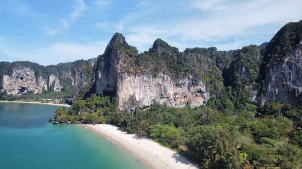 an aerial view of a sandy beach surrounded by mountains
