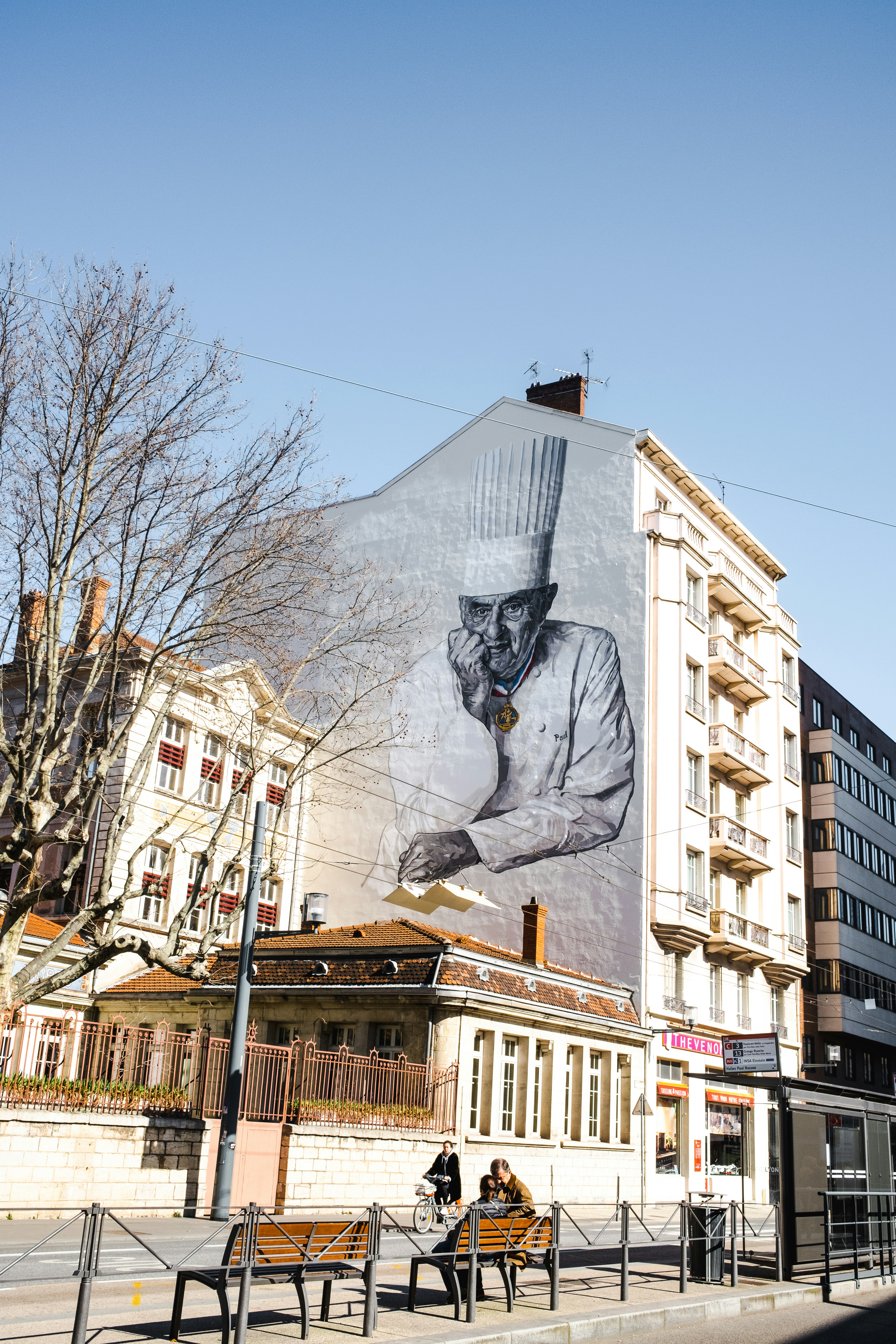 a large mural of a chef on the side of a building