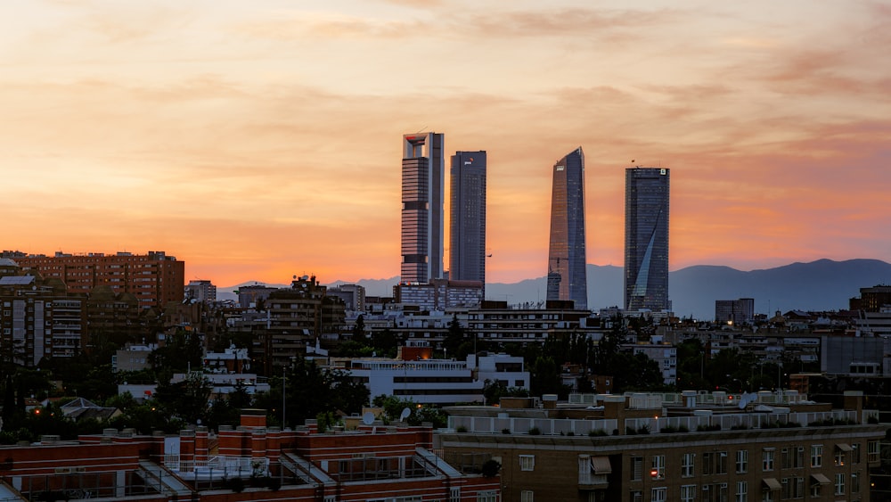 a sunset view of a city with tall buildings
