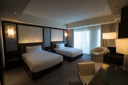 a hotel room with two beds and a chair