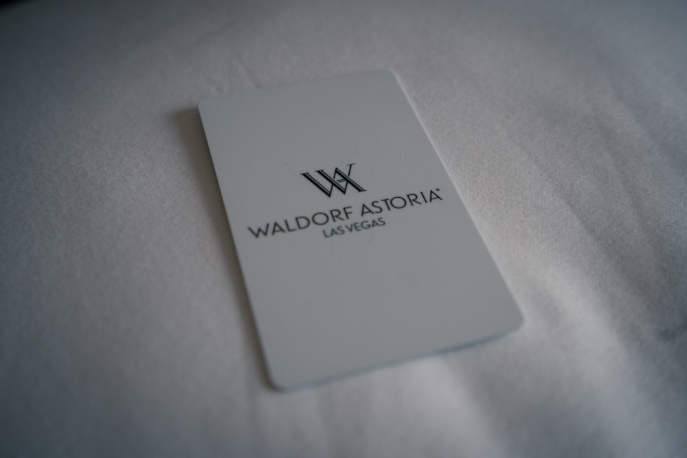 a close up of a business card on a bed