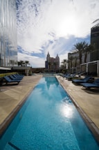 A friendly technician repairing a backyard pool under a bright Alabama sky.