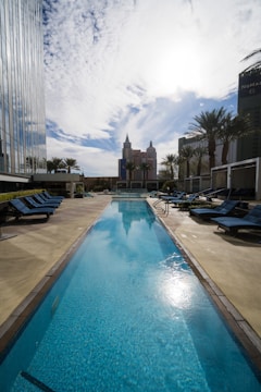 A commercial pool with clear water and lounge chairs.