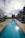 A happy customer enjoying a sparkling clear pool on a sunny day.