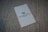 A white card with the Waldorf Astoria Las Vegas logo is placed on a textured, woven surface.